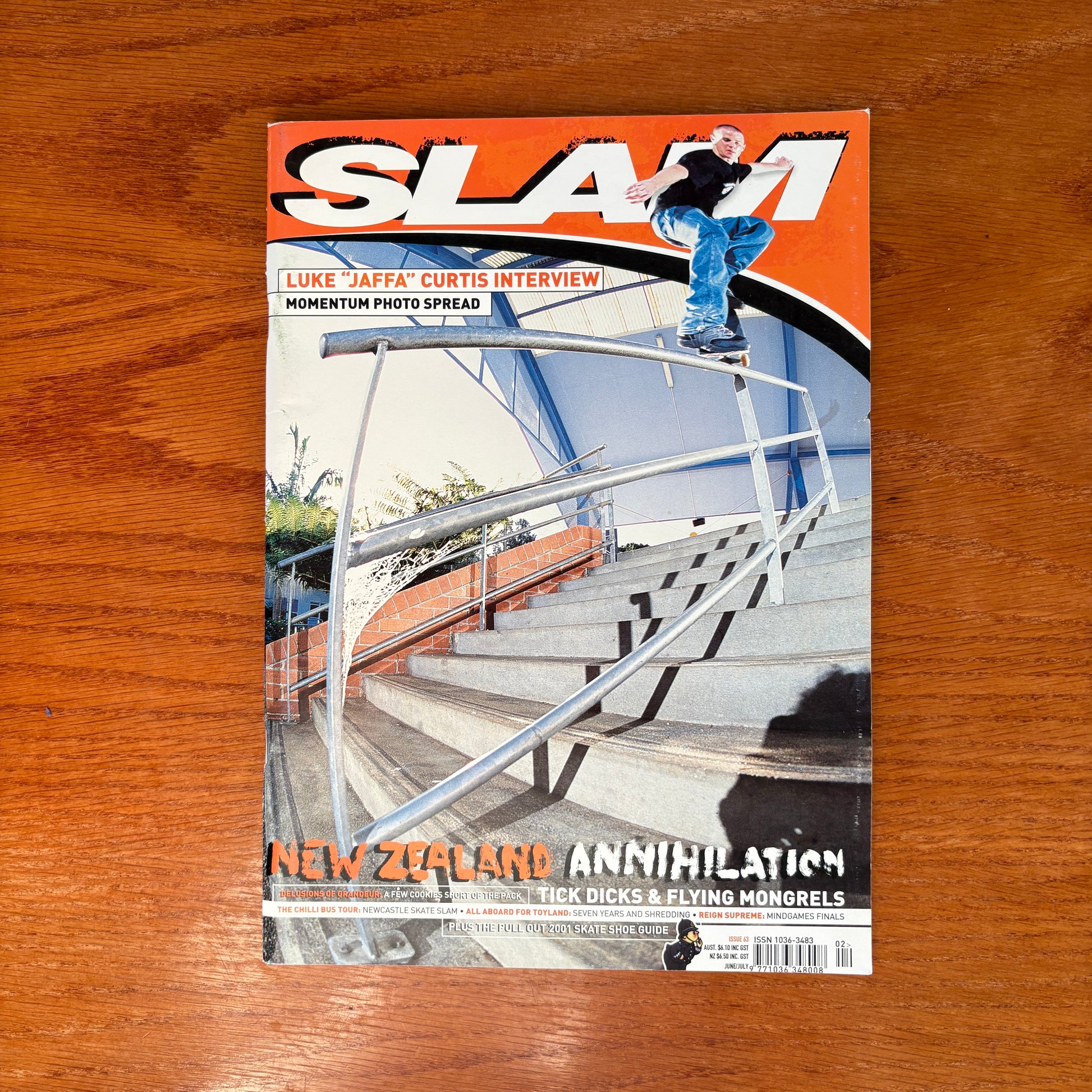 Slam #63, Australian Skateboarding magazine from 2001  with Jaffa Curtis on the cover grinding a long and steep round handrail down a large set of stairs.